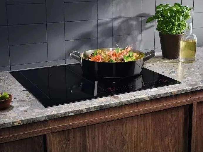 Electrolux EIS62453 индукционная варочная панель встроена в мраморную столешницу с кастрюлей на конфорке